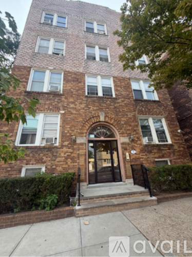 A brick building with a black door and windows.