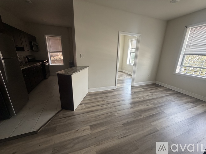 A kitchen with a refrigerator, cabinets, and a countertop is visible.