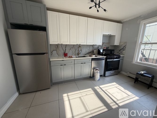 A kitchen with a refrigerator, stove, and oven.