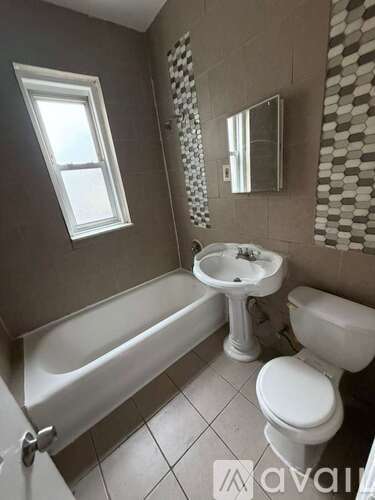 A bathroom with a white toilet, sink, and bathtub.