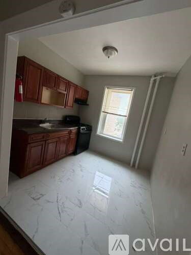 A kitchen with wooden cabinets and a marble countertop.