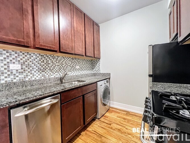 A kitchen with wooden cabinets and a black stove top.