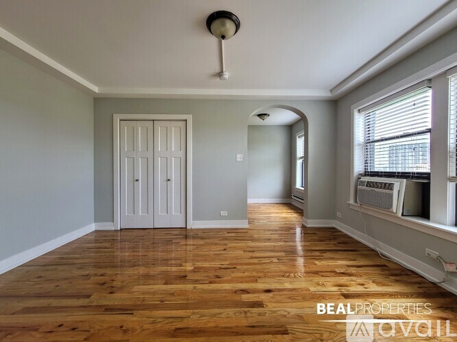 A room with wooden floors and a white door.