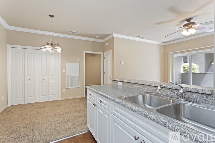 A kitchen with a sink and a ceiling fan.