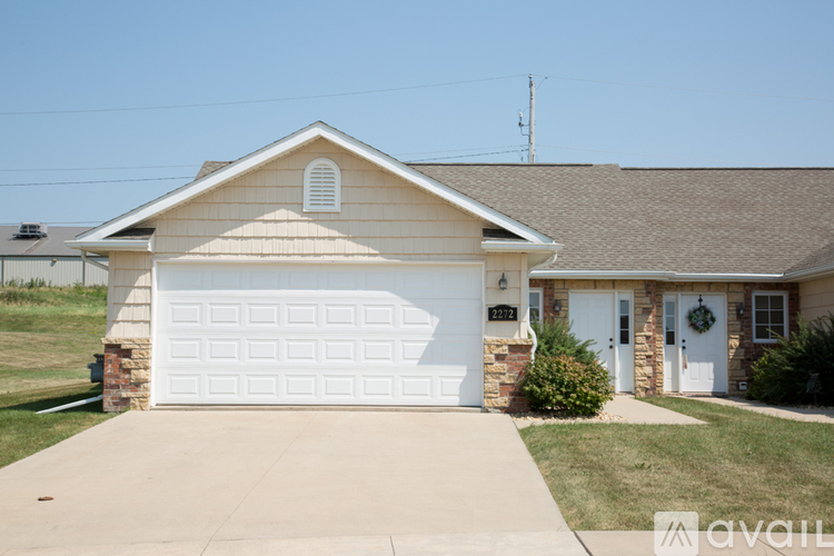 A house with a white garage door and a brown roof.