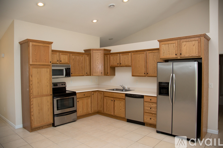 A kitchen with wooden cabinets and stainless steel appliances.