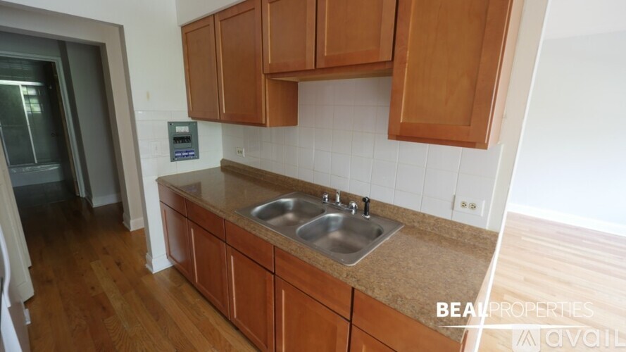 A kitchen with wooden cabinets and a sink.