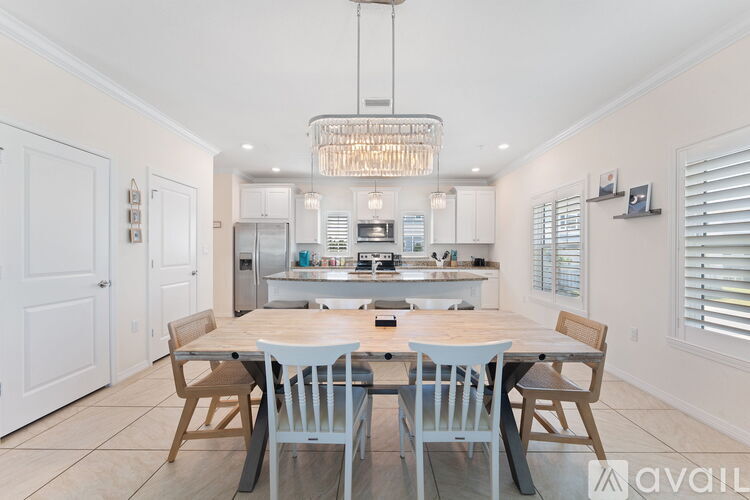 A modern kitchen with a dining table set for four.
