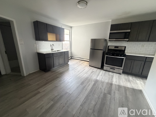 A kitchen with wooden floors and modern appliances.
