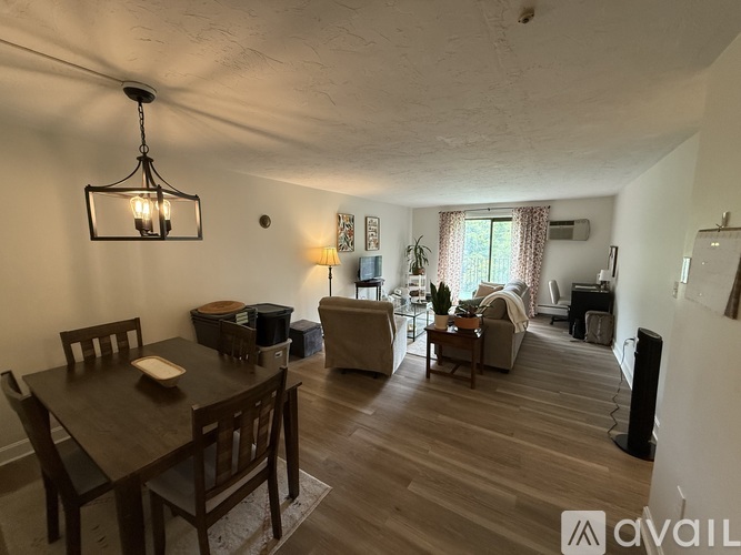 A living room with a dining table and chairs.