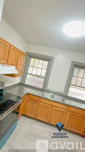 A kitchen with wooden cabinets and a window.