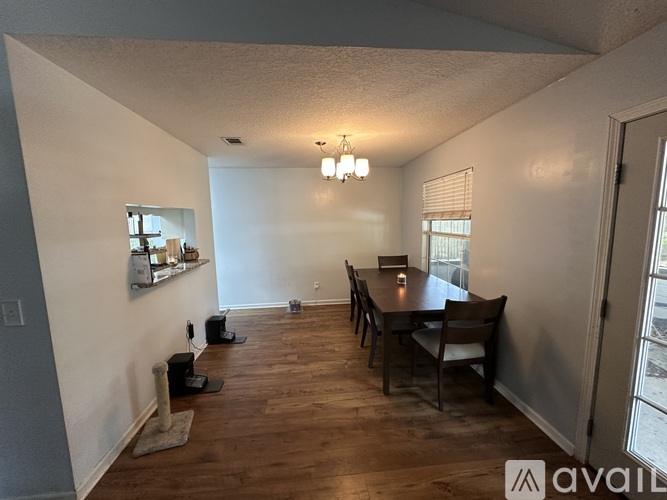 A dining room with a long table and chairs.