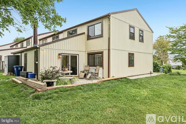 A house with a beige exterior is for sale.