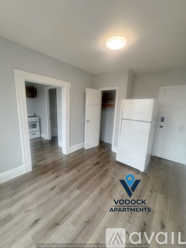 A room with a Vodock Apartments logo on the floor.