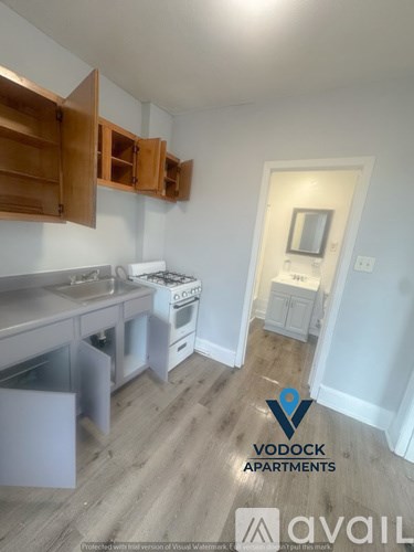 A kitchen with wooden cabinets and a white fridge.