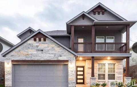 A two-story house with a garage on the ground floor.