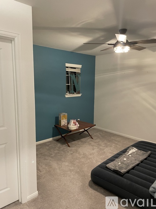 A room with a blue wall and a white door.