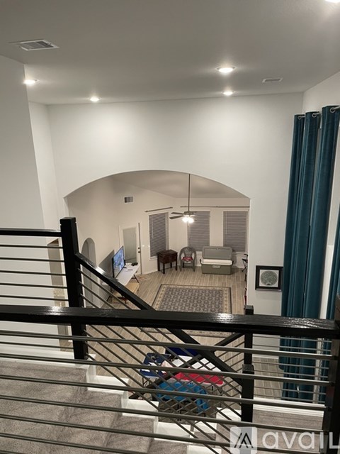A living room with a couch and a television.