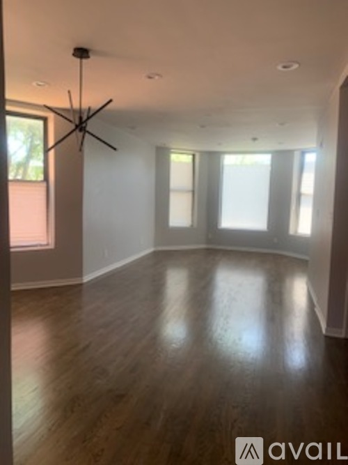 A room with wooden floors and a ceiling fan.