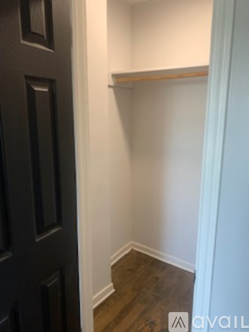 A black door is on the left and a white wall is on the right.