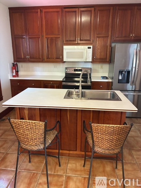 A kitchen with wooden cabinets and a white countertop.