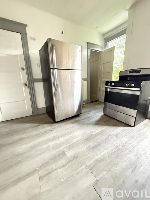 A kitchen with a stainless steel refrigerator and oven.