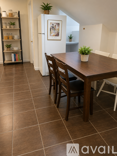 A dining room with a wooden table and chairs.
