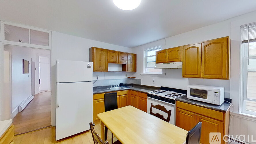 A kitchen with wooden cabinets and a white refrigerator.