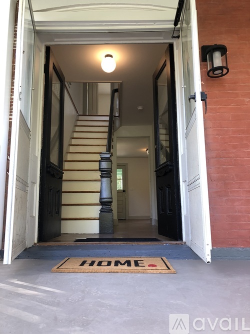 A home entrance with a doormat that says "HOME".