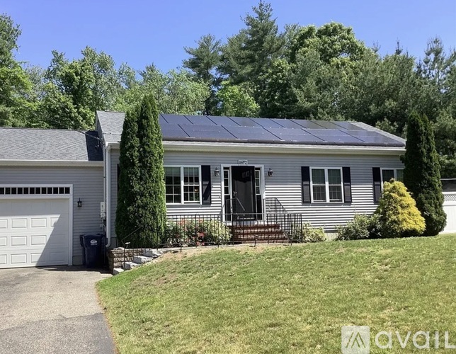 A house with solar panels on the roof is for sale.