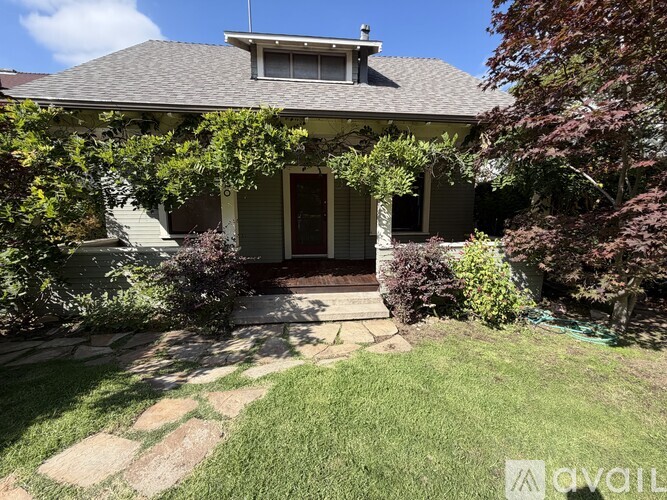 A house with a front yard and a stone pathway leading to the front door.