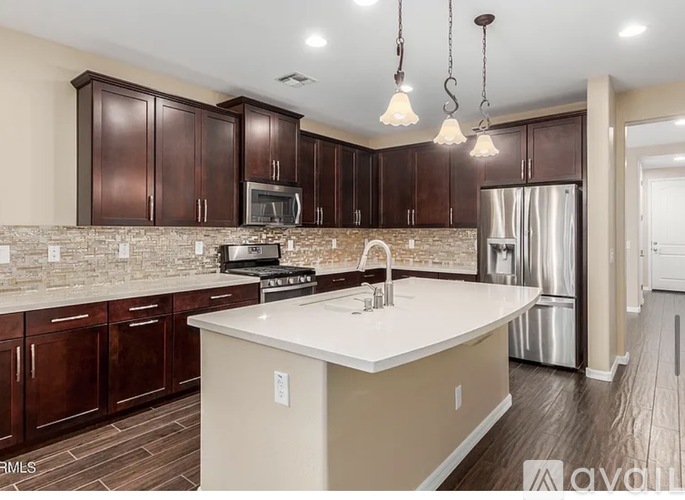 A kitchen with brown cabinets and a white island.