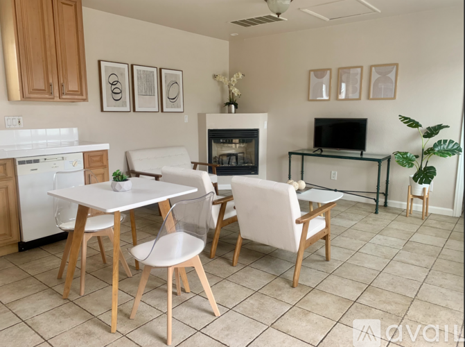 A kitchen with a white table and chairs.