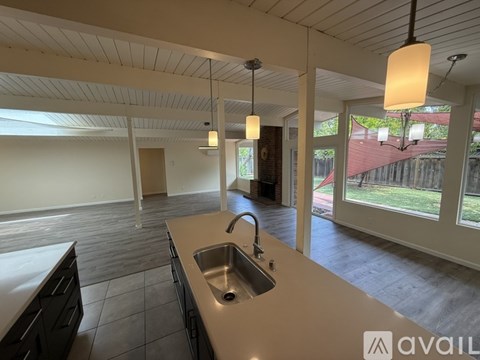A kitchen with a sink and a counter is available for rent.