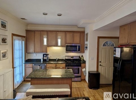 A kitchen with wooden cabinets and a granite countertop.