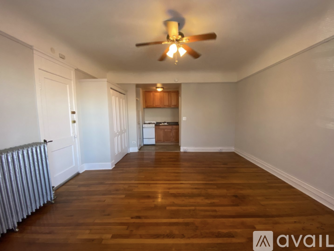 A room with wooden floors and a ceiling fan.