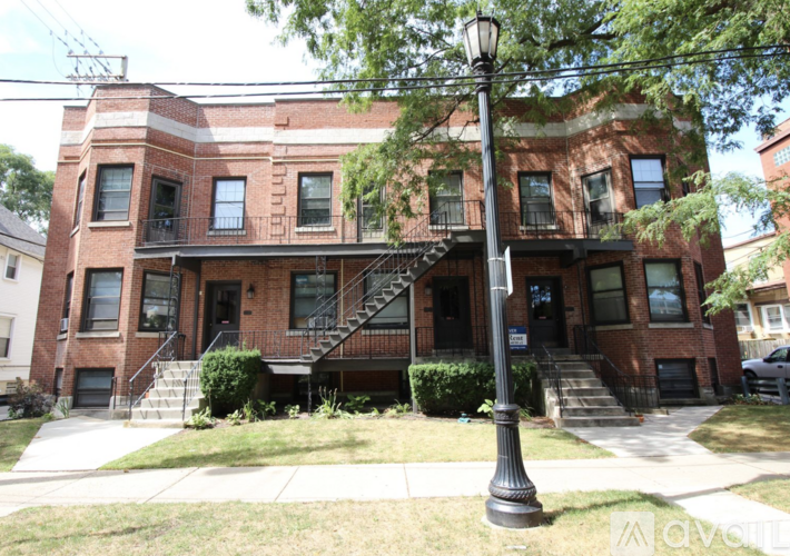 A red brick building with a black lamp post in front.