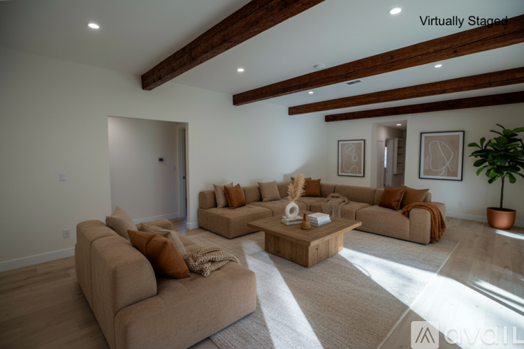 A living room with a brown sofa and a wooden coffee table.