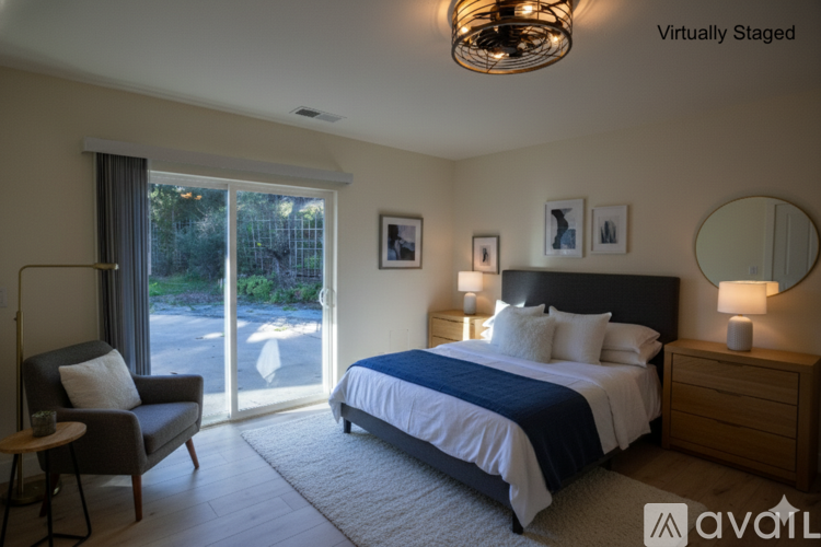 A bedroom with a bed, nightstand, and chair.