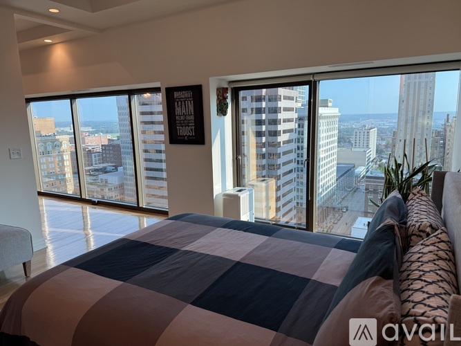 A bedroom with a large bed and a view of the city.