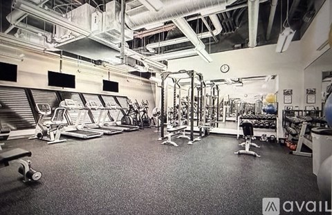 A gym with a variety of equipment including weights and machines.