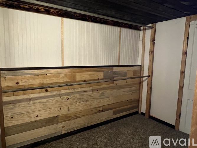 A room with wooden walls and a carpeted floor.
