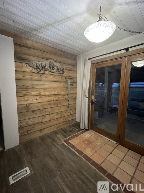 A room with wooden walls and a tiled floor.