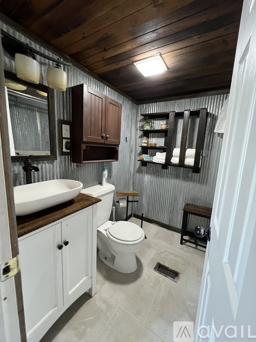 A bathroom with a white toilet and a white sink.