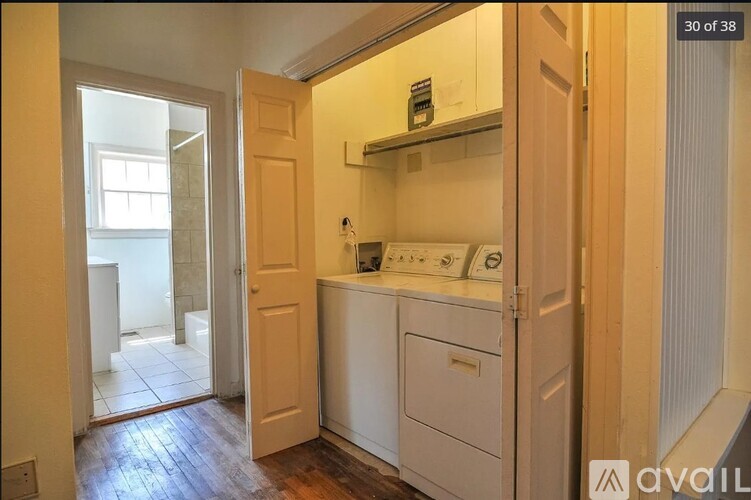 A small kitchen with a white dishwasher and a white cabinet.