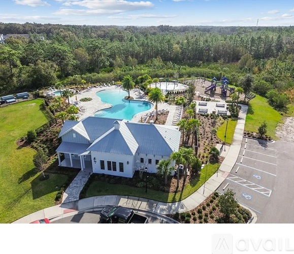 A large white house with a pool in the backyard.