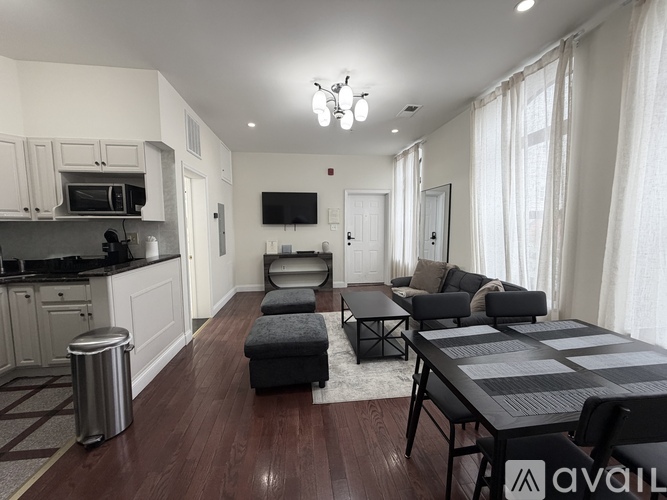 A modern kitchen with a dining table and chairs.