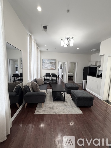 A living room with a black coffee table and grey couches.