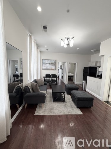 A living room with a black coffee table and grey couches.