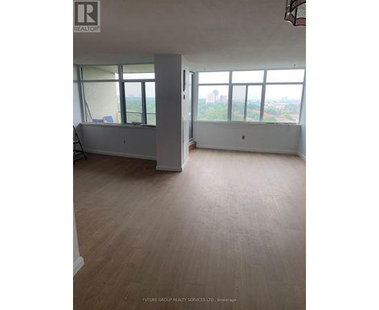 A large empty room with a view of the city.